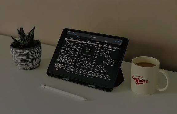 A tablet displaying wireframes